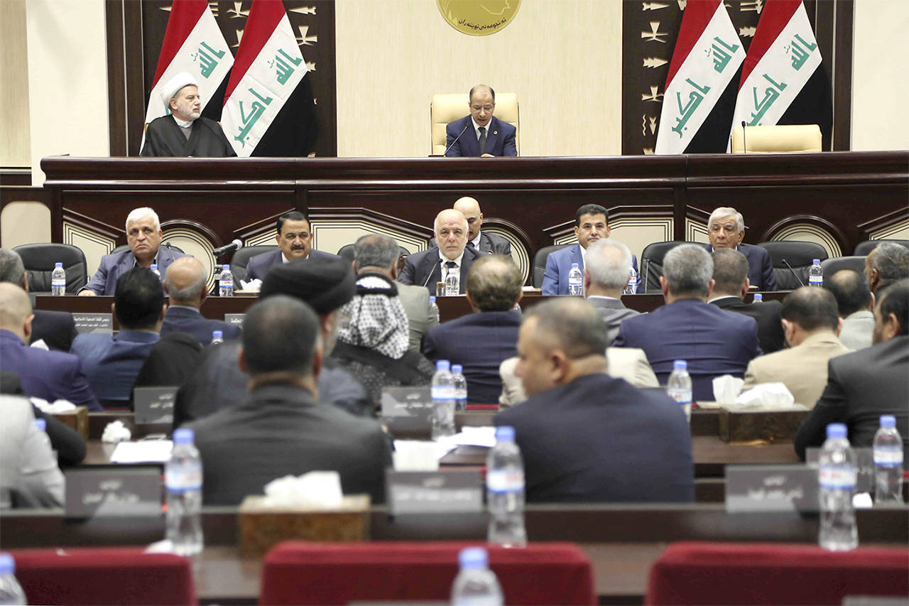 Iraqi Prime Minister Haider al-Abadi (center) attends a session of the Iraqi Parliament in Baghdad, Iraq, on Wednesday. (AP Photo/Karim Kadim)