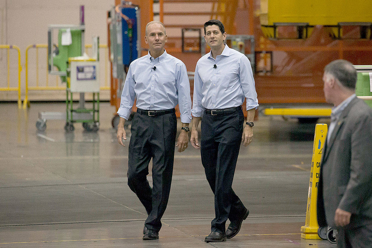 House Speaker Paul Ryan (right) arrives with Dennis Muilenburg, chairman and chief executive officer of Boeing, to a town hall meeting at the Boeing factory in Everett on Aug. 24. (David Ryder / Bloomberg News)