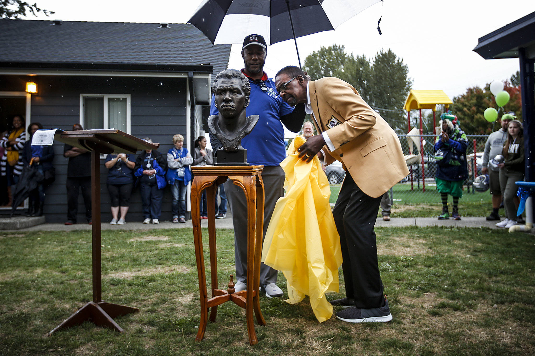 Recent Pro Football Hall of Fame inductee and former Seahawks safety, Kenny Easley, checks out a replica bust of himself during a ceremony held in his honor at Greater Trinity Academy in Everett on Sept. 30, 2017. (Ian Terry / The Herald)