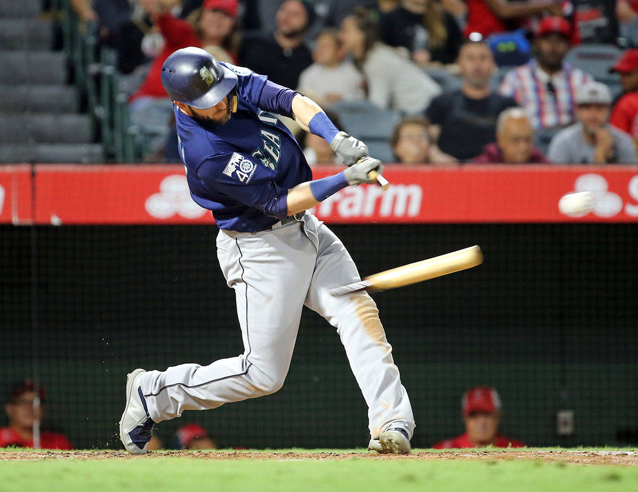 Seattle’s Mitch Haniger breaks his bat on a base hit to center field in the third inning of Saturday’s game in Anaheim, Calif. (AP Photo/Reed Saxon)
