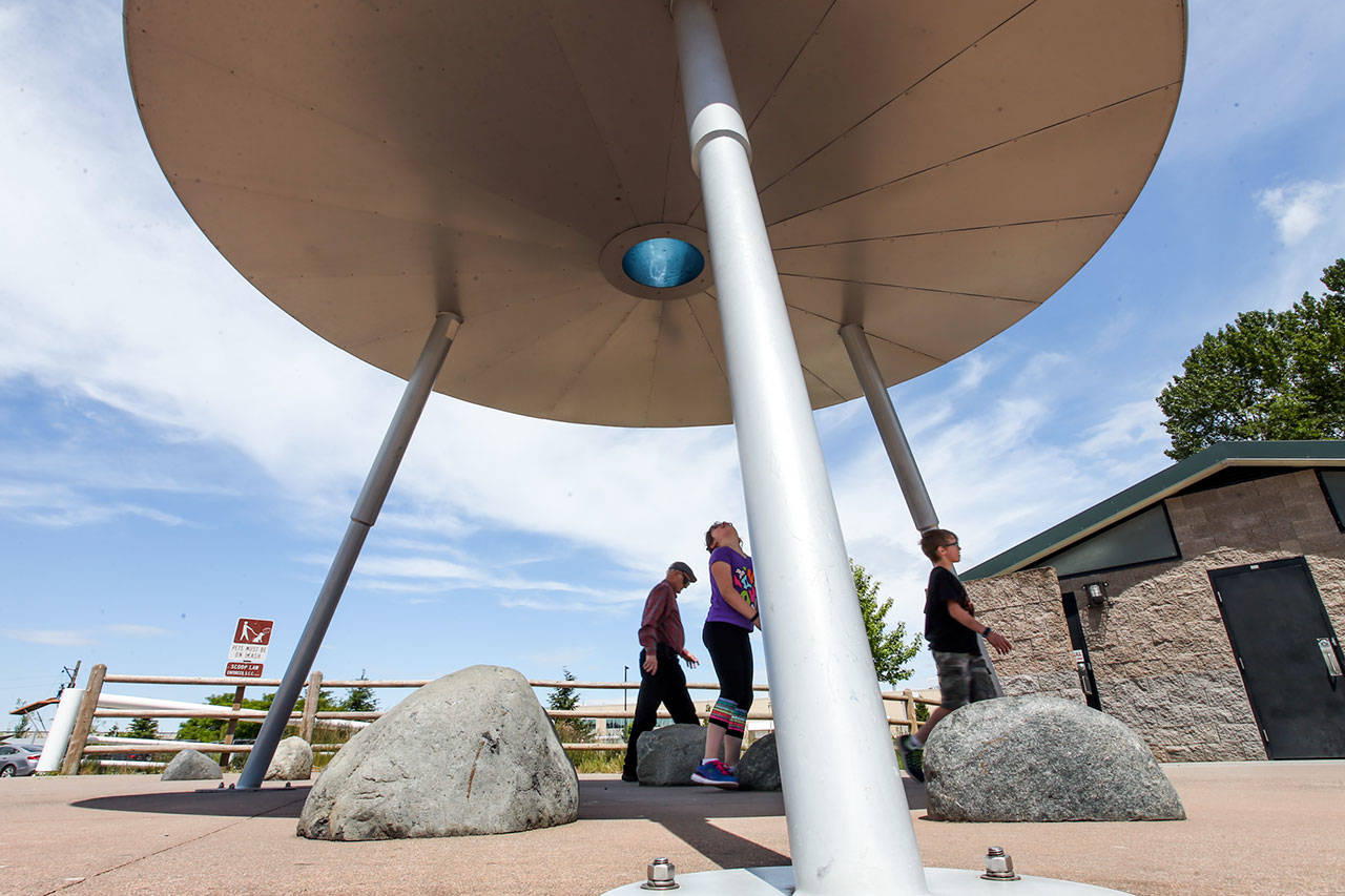 “Landing Zone,” created by Peter Reiquam, is the title of the giant UFO-style sculpture at the Paine Field Community Park playground. It is 16 feet wide and 12 feet high. (Kevin Clark / The Herald)