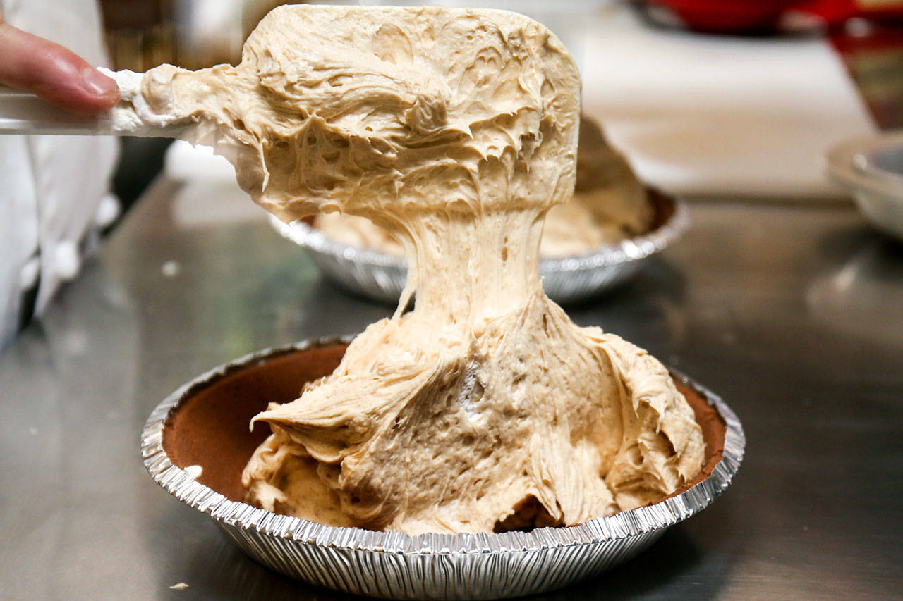 The rich mix of cream cheese, peanut butter and other ingredients are poured into a pie crust to make Bucks peanut butter pie at Bucks Cafe in Everett. (Kevin Clark / The Herald)