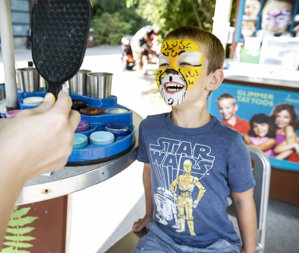 Wyatt Barth, 6, of Issaquah, checks out his jaguar-themed face paint at the Woodland Park Zoo. (Ian Terry / The Herald)
