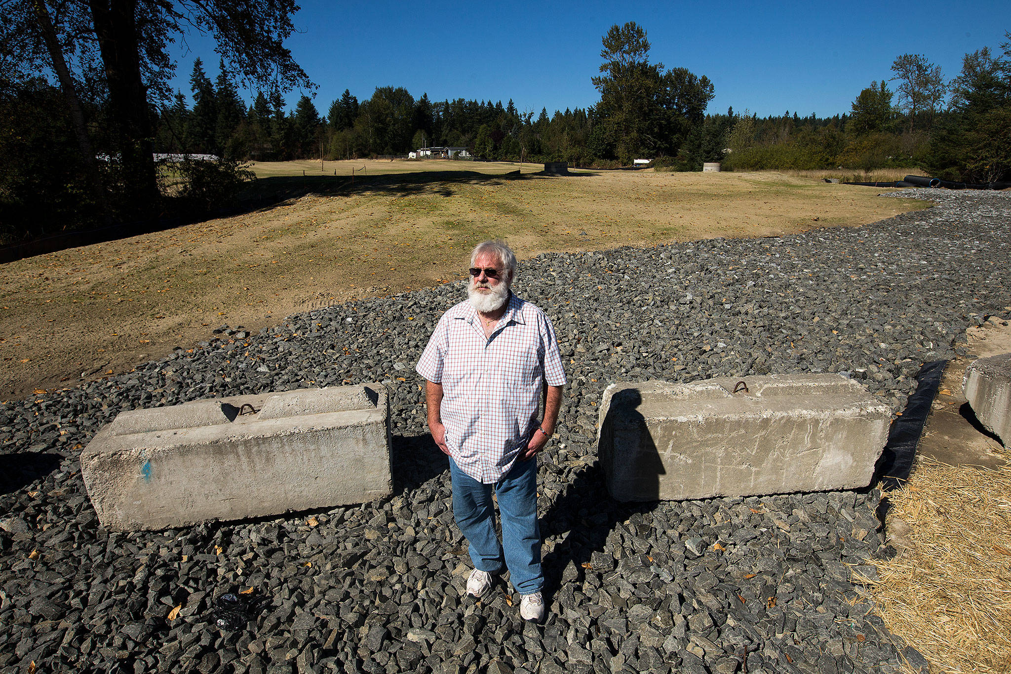 Jeff Salisbury stands in front of an 11-acre site that heavy equipment operators had cleared, without permits, along Broadway Avenue in Maltby, on Wednesday. Shipley and others blew the whistle in a case involving truck maker OSW Equipment & Repair that has turned into the most glaring code-enforcement case in recent memory in Snohomish County. (Andy Bronson / The Herald)