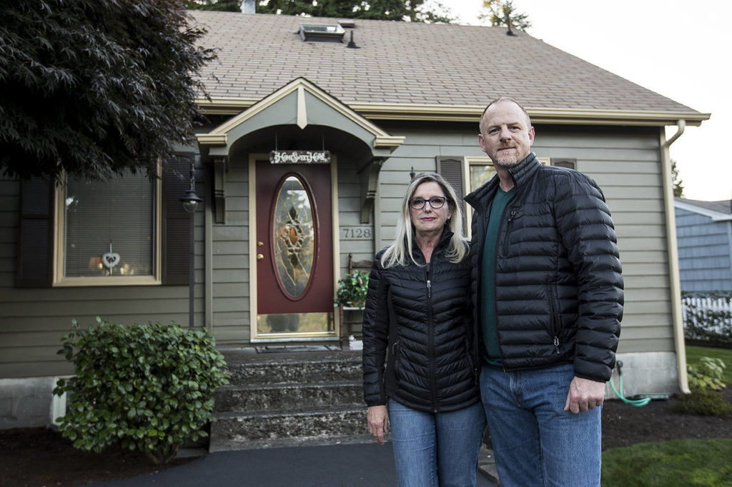 Jeff and Fran True stand in the driveway of their Beverly Boulevard home in Everett. (Ian Terry / The Herald)
