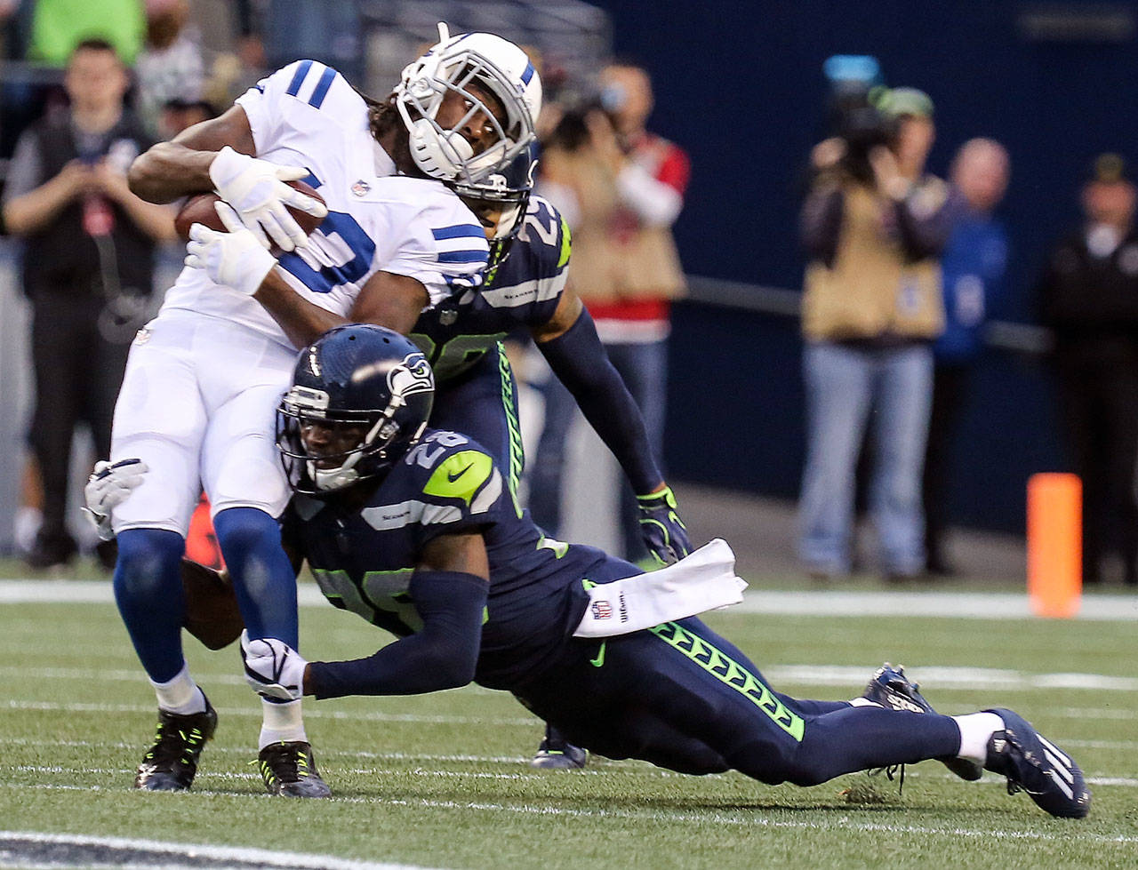 Colts wide receiver T.Y. Hilton is tackled by Seahawks corner back Justin Coleman Sunday night at CenturyLink Field in Seattle. (Kevin Clark / The Herald)