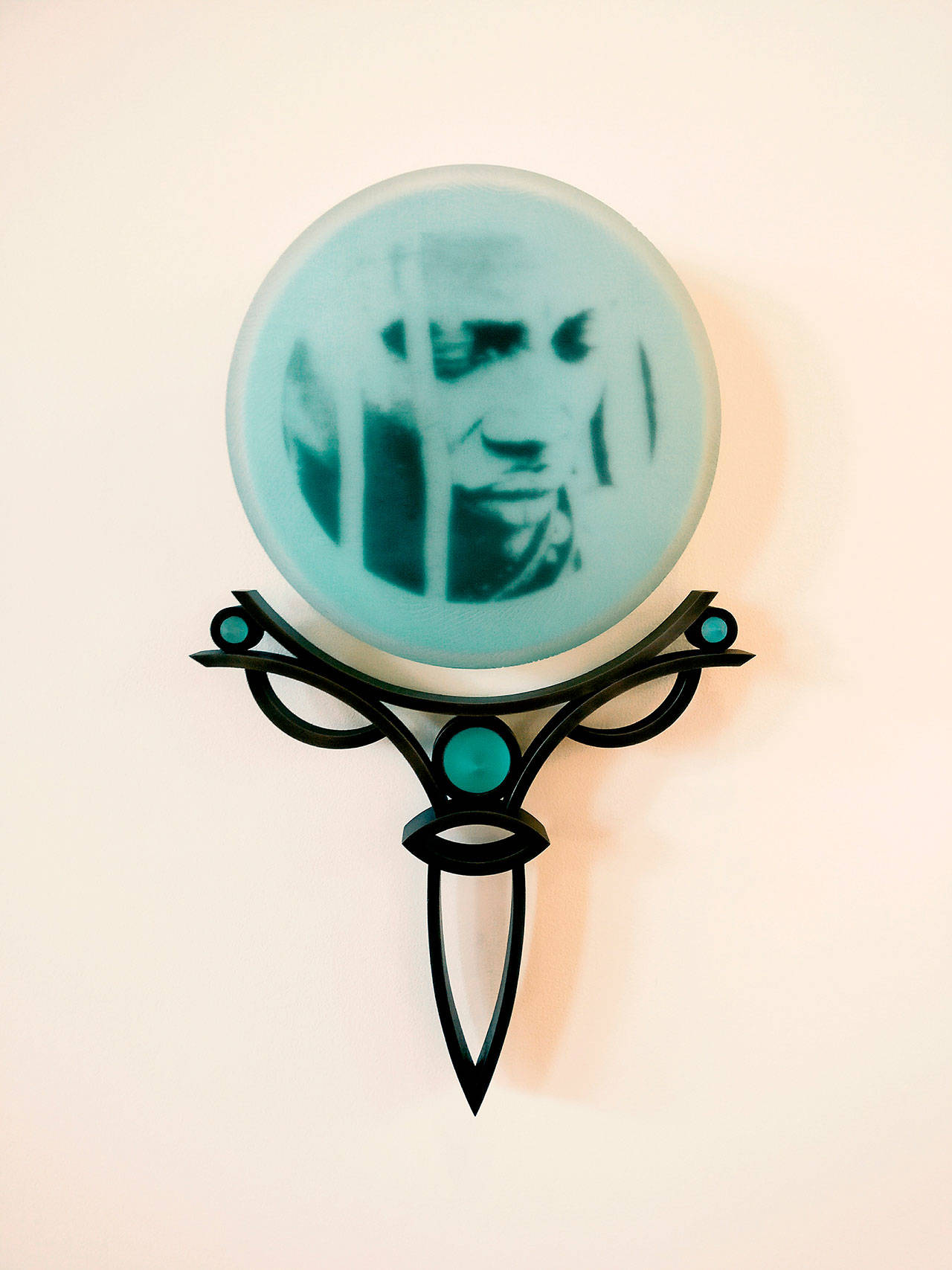 “Celadon Himba” 2014 — original photography, screen-printed, kiln-fired, blown, carved and sandblasted glass and steel, by Jenny Pohlman and Sabrina Knowles. Exhibited at the Schack through Nov. 4.