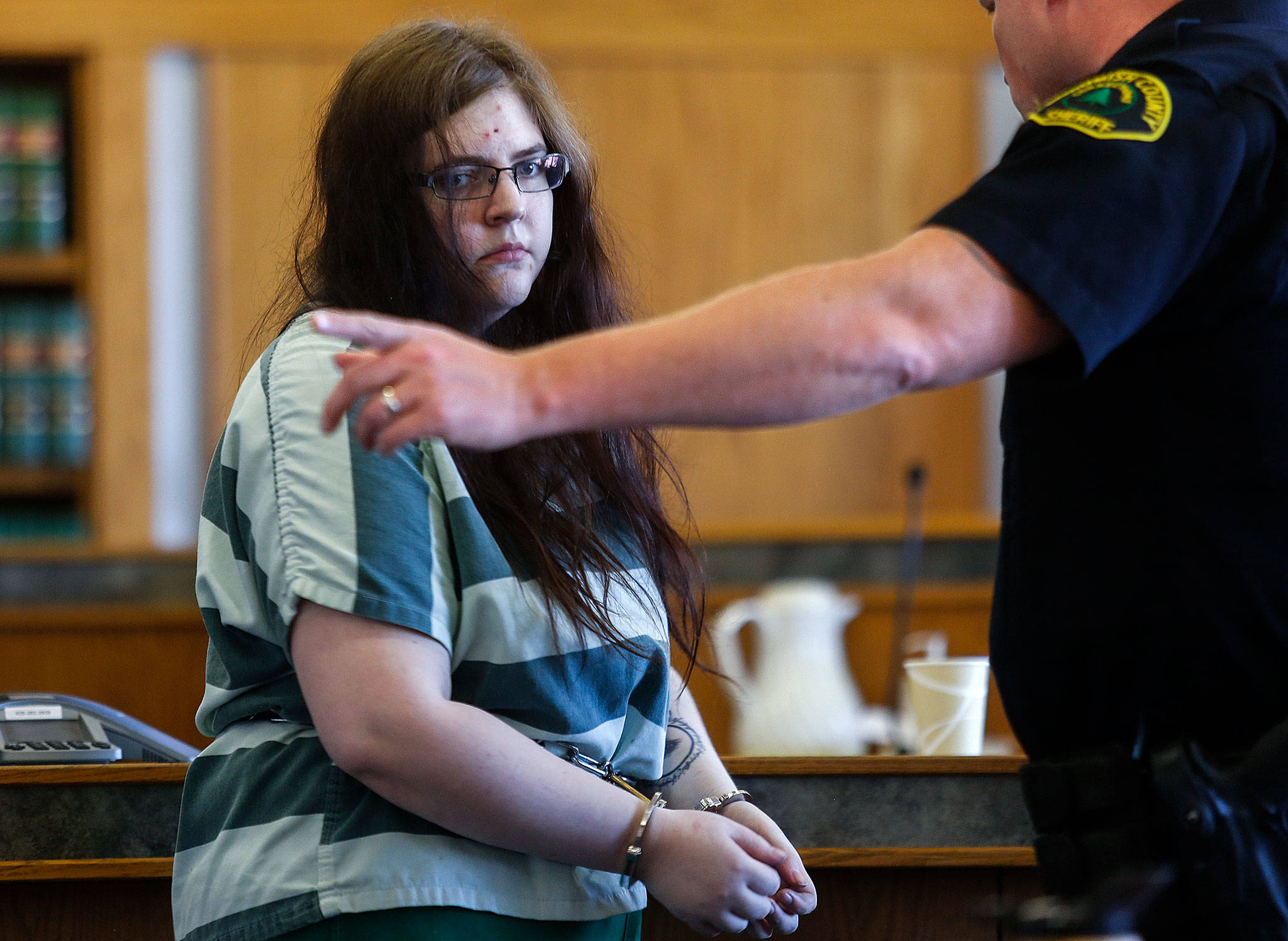 A Snohomish County Corrections officer takes Amy Brown from the courtroom following sentencing Tuesday by Superior Court Judge Michael Downes. (Dan Bates / The Herald)