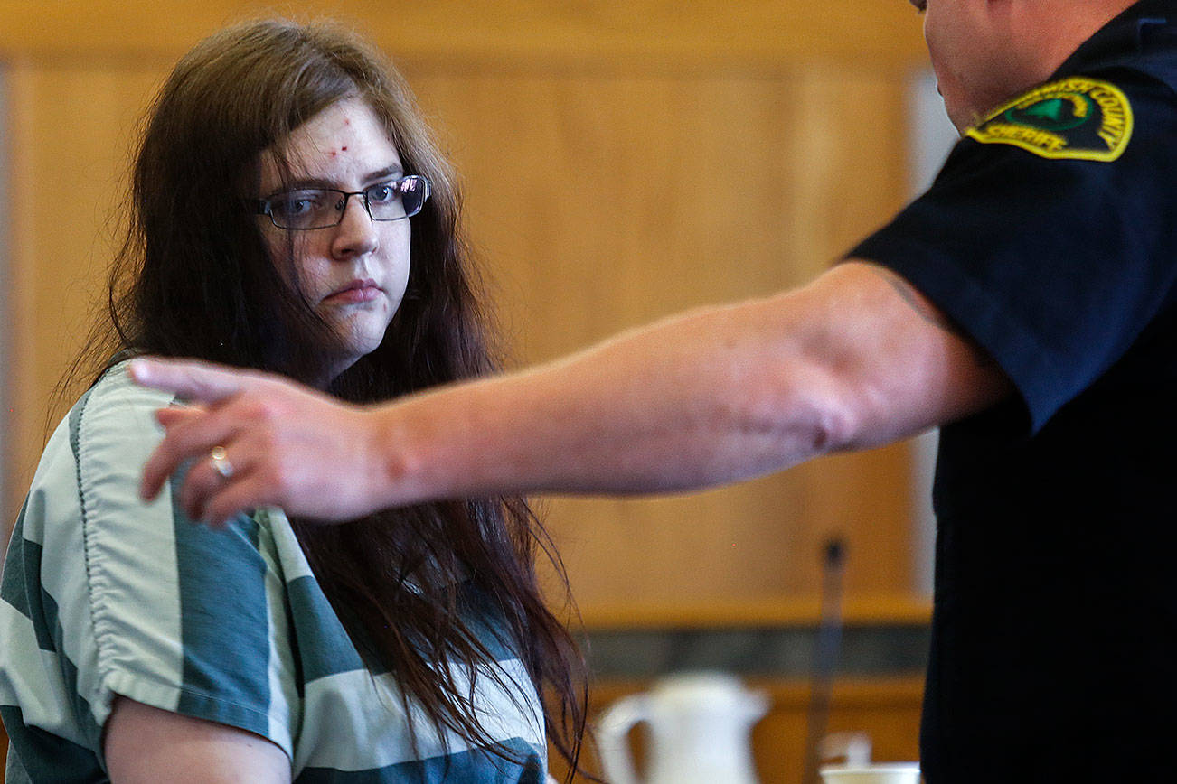 A Snohomish County Corrections officer takes Amy Brown from the courtroom follwing sentencing Tuesday by Superior Court Judge Michael Downes. (Dan Bates / The Herald)