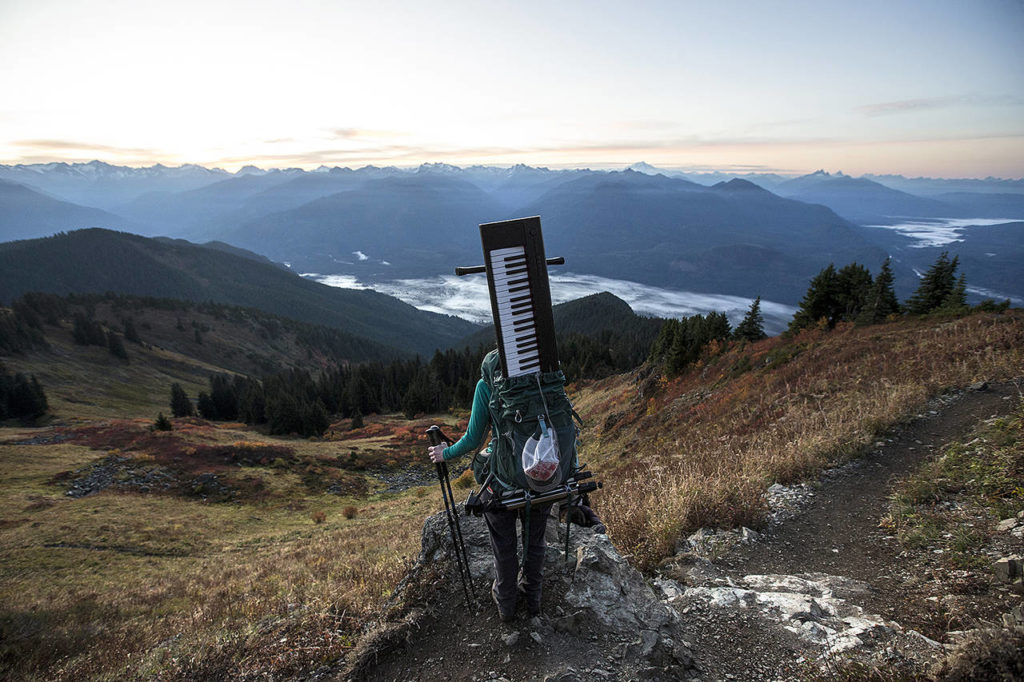 With her Yahama Piaggero keyboard stowed away in her backpack, Rose Freeman stops to take in the view during an early morning ascent of Sauk Mountain on Oct. 5. (Ian Terry / The Herald)
