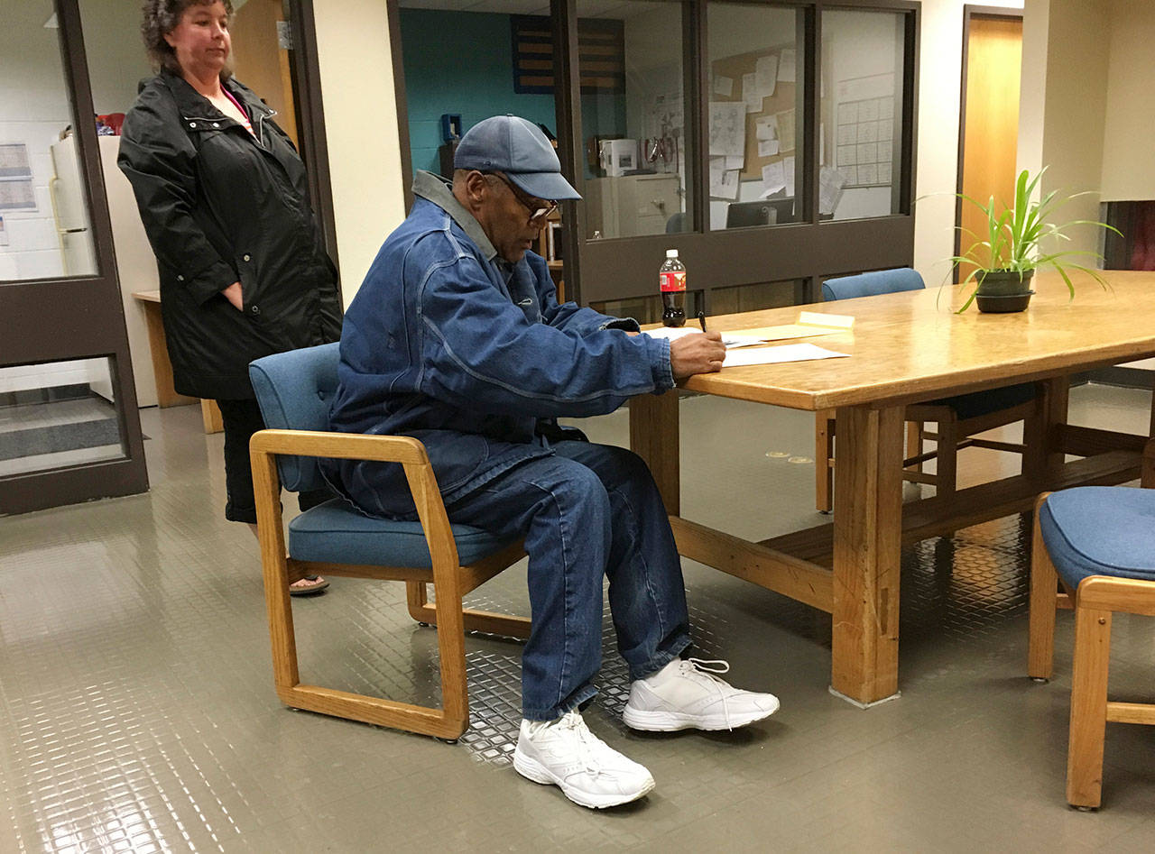 Former football legend O.J. Simpson signs documents at the Lovelock Correctional Center on Saturday in Lovelock, Nevada. (Brooke Keast/Nevada Department of Corrections via AP)
