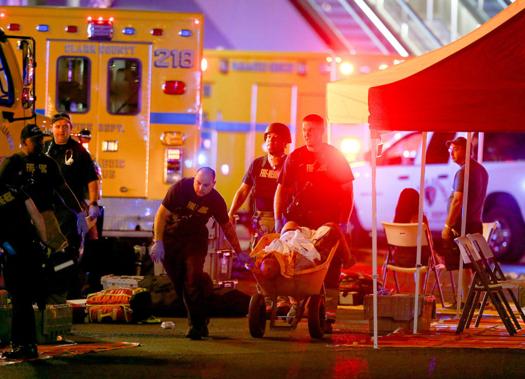 A wounded person is carried on a wheelbarrow as Las Vegas police respond during an active shooter situation on the Las Vegas Strip in Las Vegas late Sunday. (Chase Stevens/Las Vegas Review-Journal via AP)

