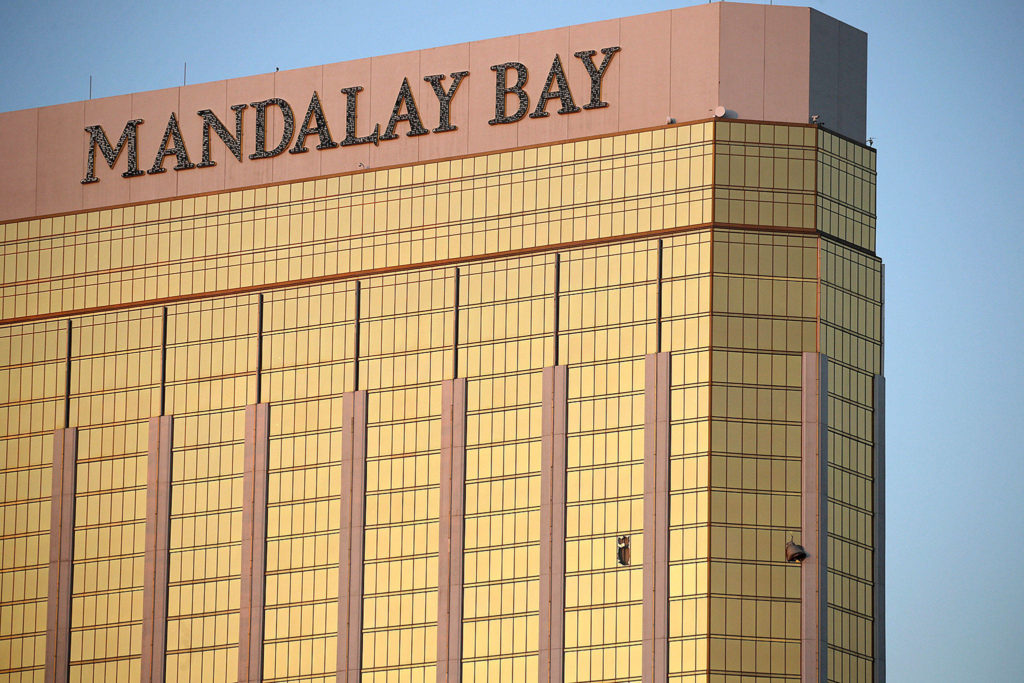 Drapes billow out of broken windows at the Mandalay Bay resort and casino on Monday on the Las Vegas Strip following a deadly shooting at a music festival in Las Vegas. (AP Photo/John Locher) 
