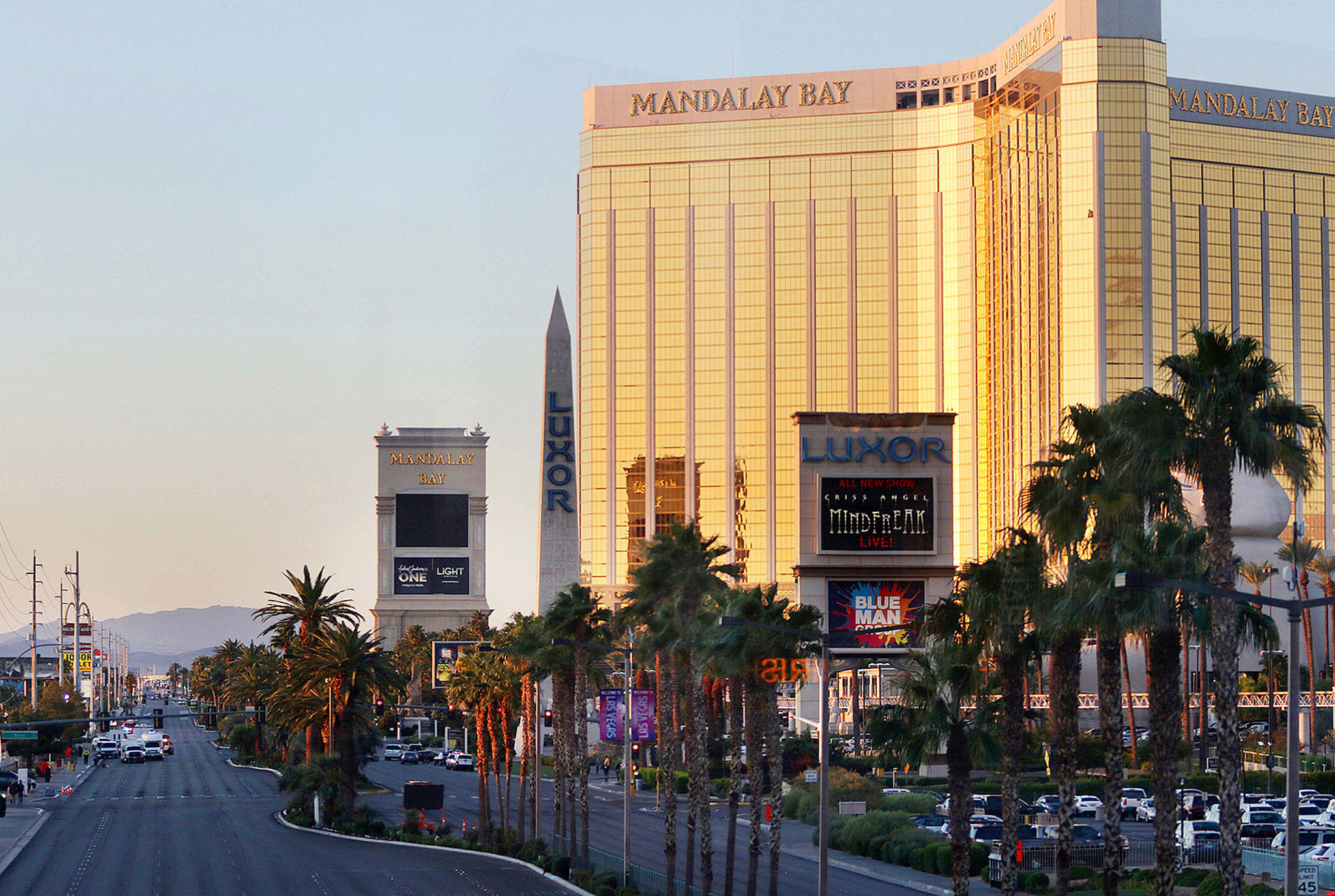 Police block a road on the Las Vegas Strip near the Mandalay Bay hotel and casino shortly after sunrise Monday in Las Vegas. (AP Photo/Ronda Churchill)