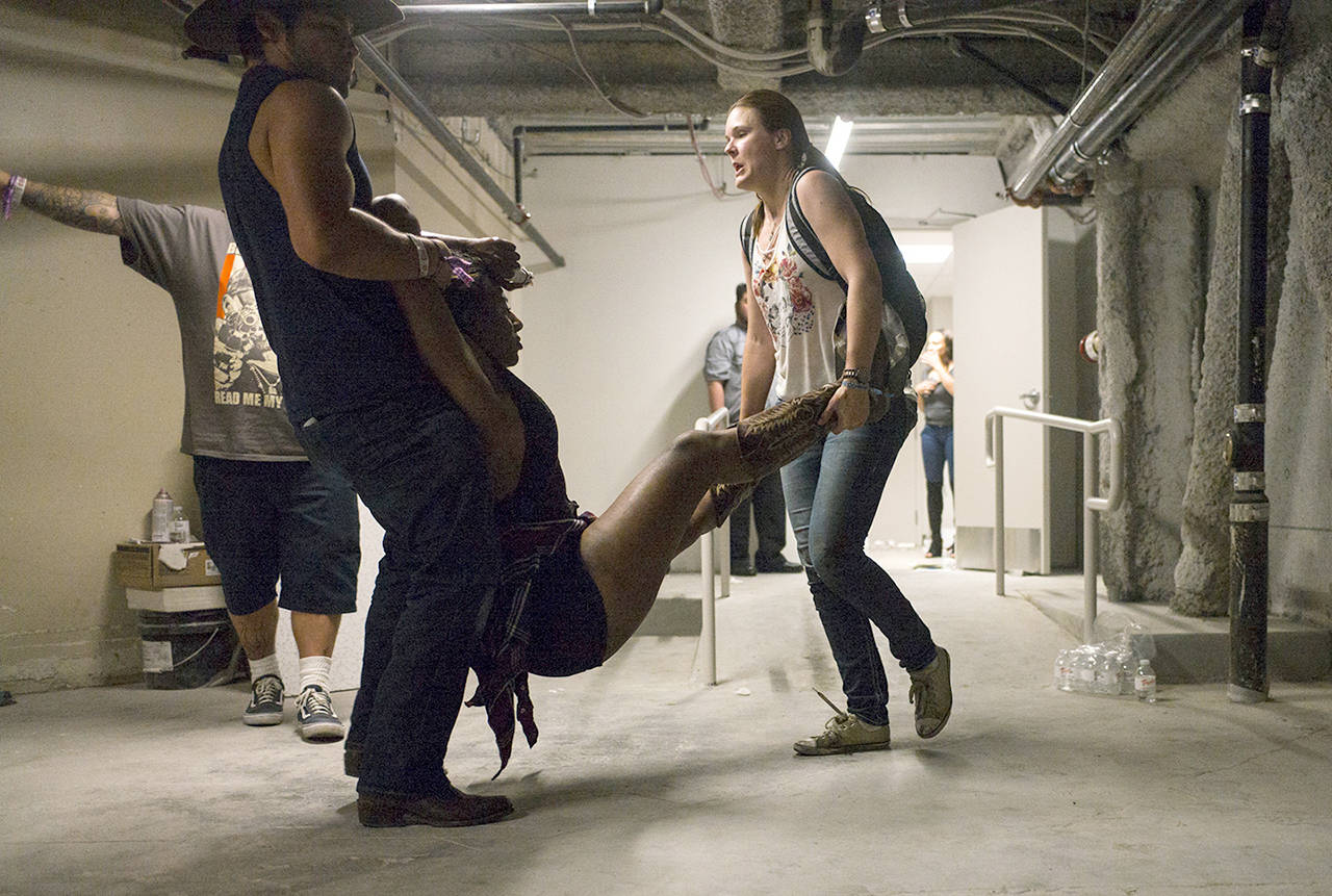 People assist a wounded woman at the Tropicana during an active shooter situation on the Las Vegas Strip in Las Vegas on Sunday. (Chase Stevens/Las Vegas Review-Journal via AP)