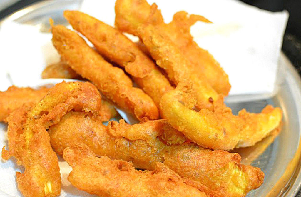 Bajji are Indian-style vegetable fritters. Baby corn bajji is dipped in a spicy lentil and rice flour batter and then fried. Reshma Seetharam/For The Herald)
