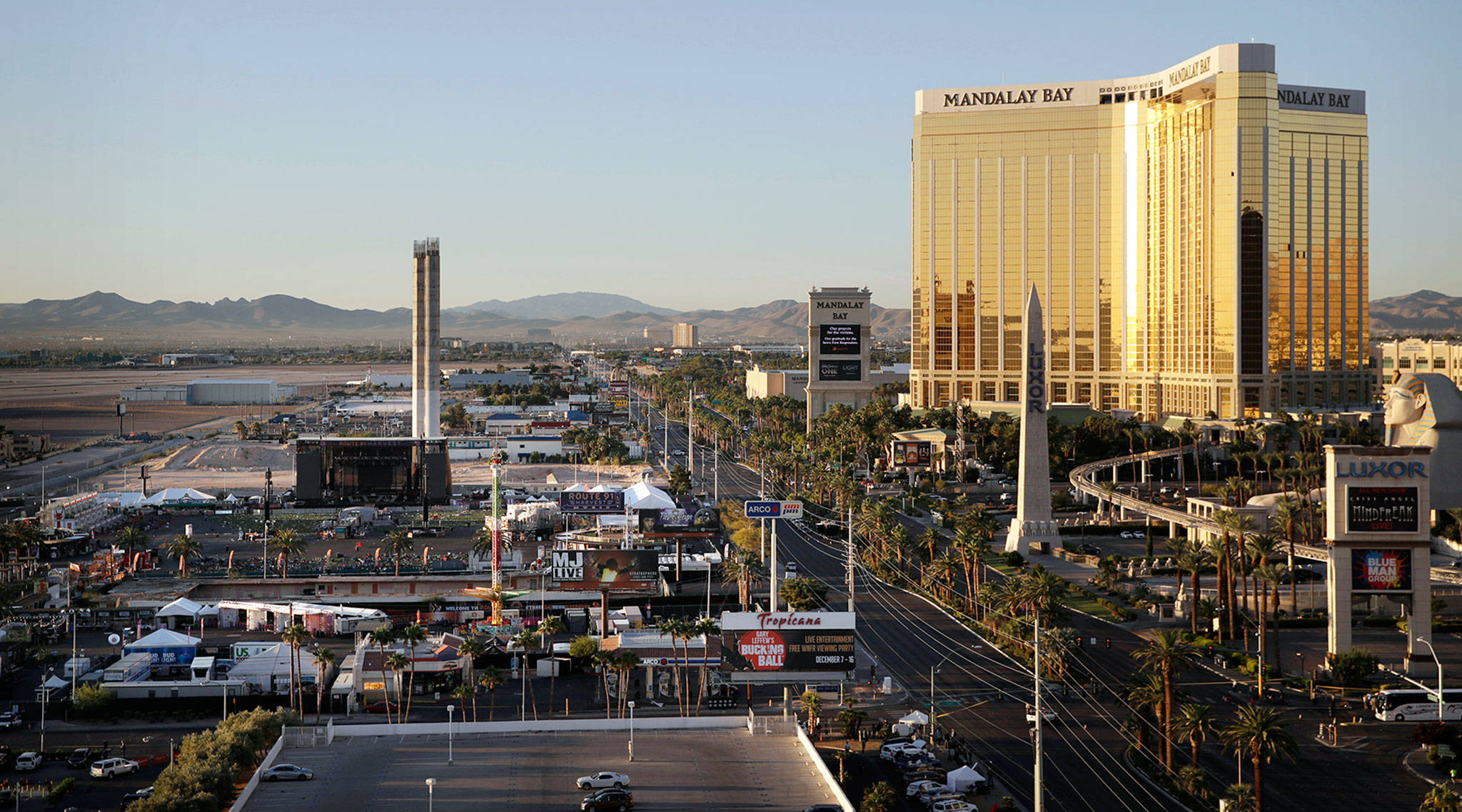 The Mandalay Bay resort and casino (right) overlooks the outdoor festival grounds across the street (left) in Las Vegas where 59 people died Sunday. (John Locher / Associated Press)