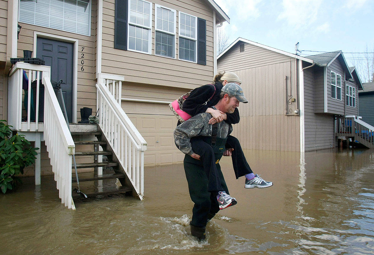 Water floods a home in Snohomish five years ago. With disasters striking the South, the Caribbean and Mexico — and storm season approaching — insurance experts say now is a good time review what homeowner policies cover and don’t. (Sarah Weiser / The Herald)