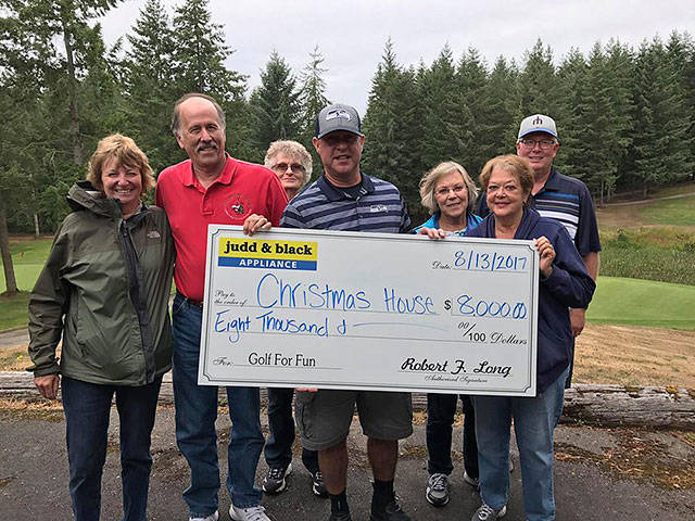 Christmas House board members accept an $8,000 check from Cory Long at the conclusion of Judd & Black’s annual charity golf tournament. From left: Christmas House board member Robin Murphy, president Gregg Milne, Sylvia May, Judd & Black’s Cory Long and other members Charlie Wood, Lynn Luscher and Larry Lark. (Contributed photo)