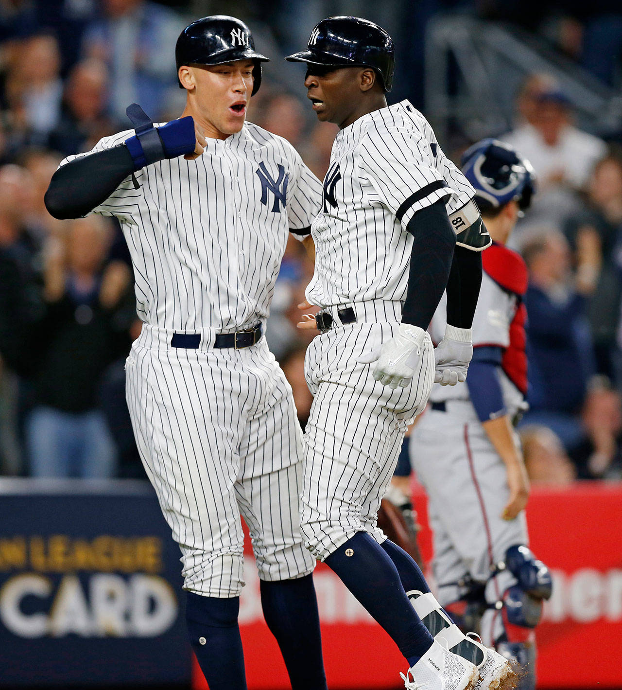 The Yankees’ Aaron Judge (left) and Didi Gregorius celebrate at the plate after Judge scored on Gregorius’ first-inning, three-run home run in the American League wild-card game against the Twins on Oct. 3, 2017, in New York. (AP Photo/Kathy Willens)