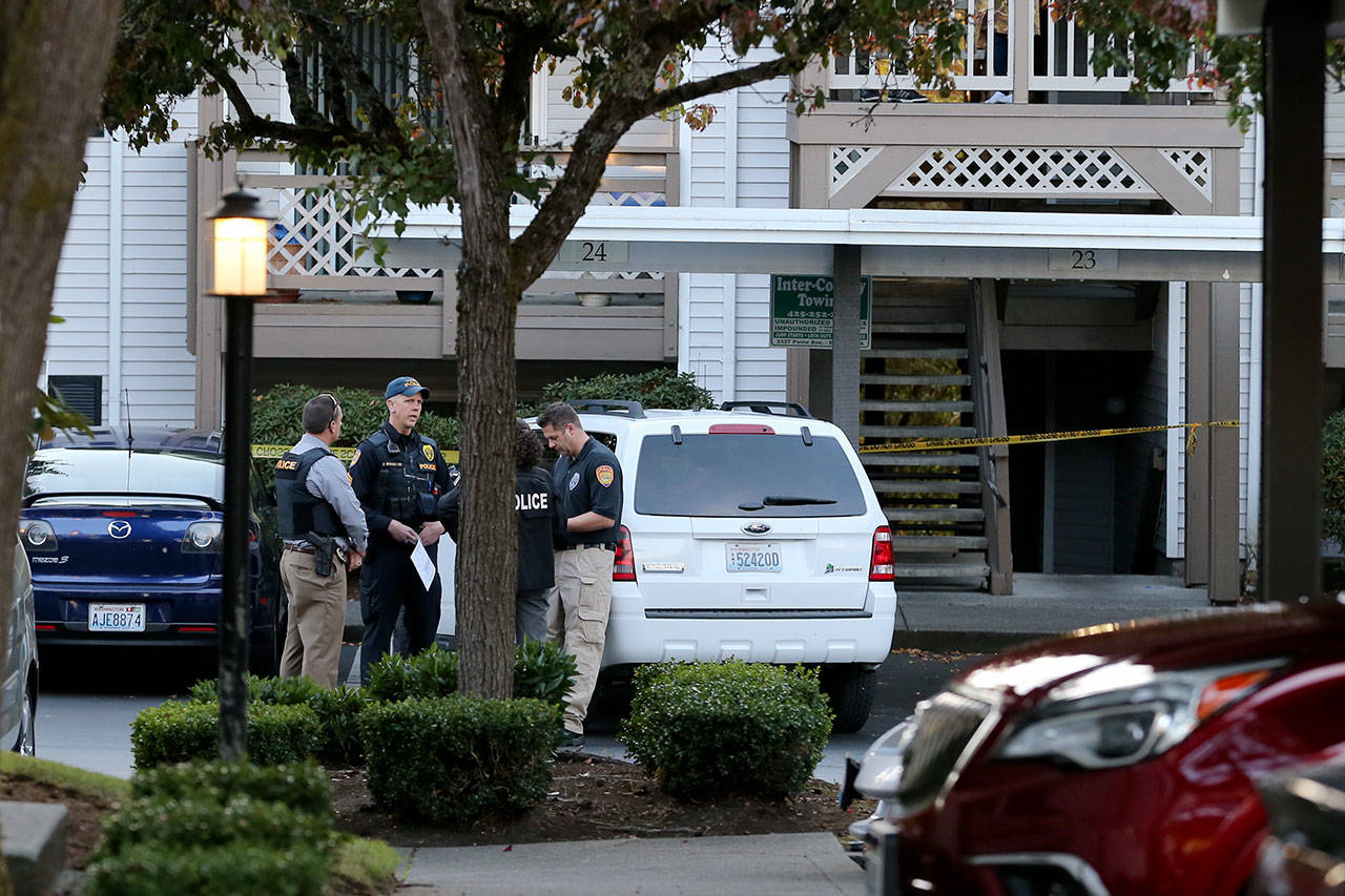 Members of the Everett Police Department confer at the scene where a boy was found shot. (Kevin Clark / The Herald)