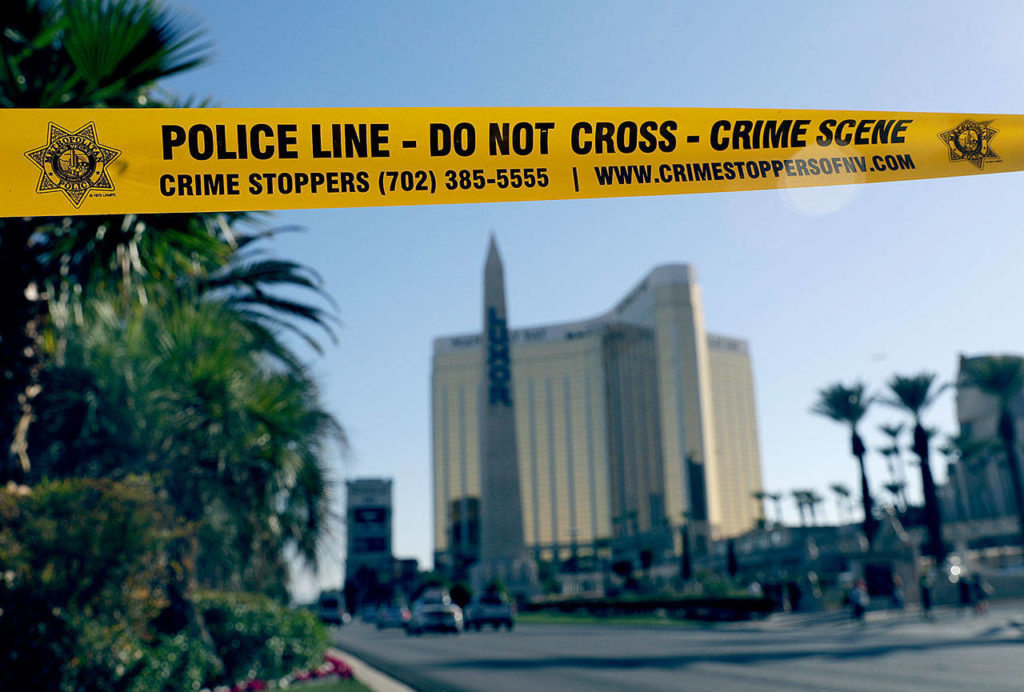 Part of Reno Avenue near South Las Vegas Boulevard is blocked with police tape Wednesday in the aftermath of Sunday’s mass shooting in Las Vegas. (AP Photo/Marcio Jose Sanchez) 
