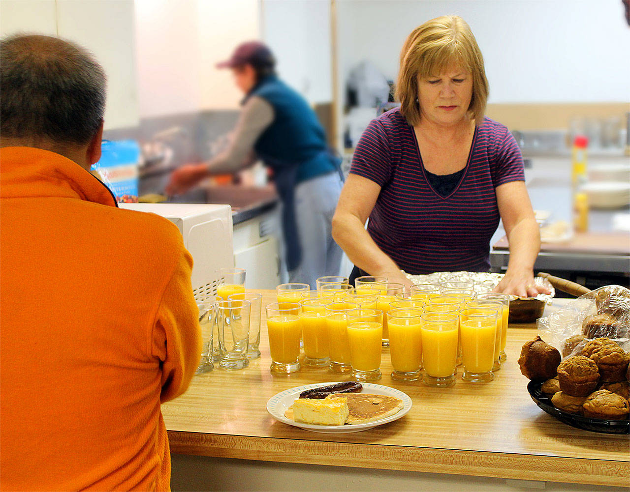 Janice Corbett and other volunteers prepare to serve 125 breakfasts for an Edmonds Bicycle Advocacy Group fundraiser. (Contributed photo)