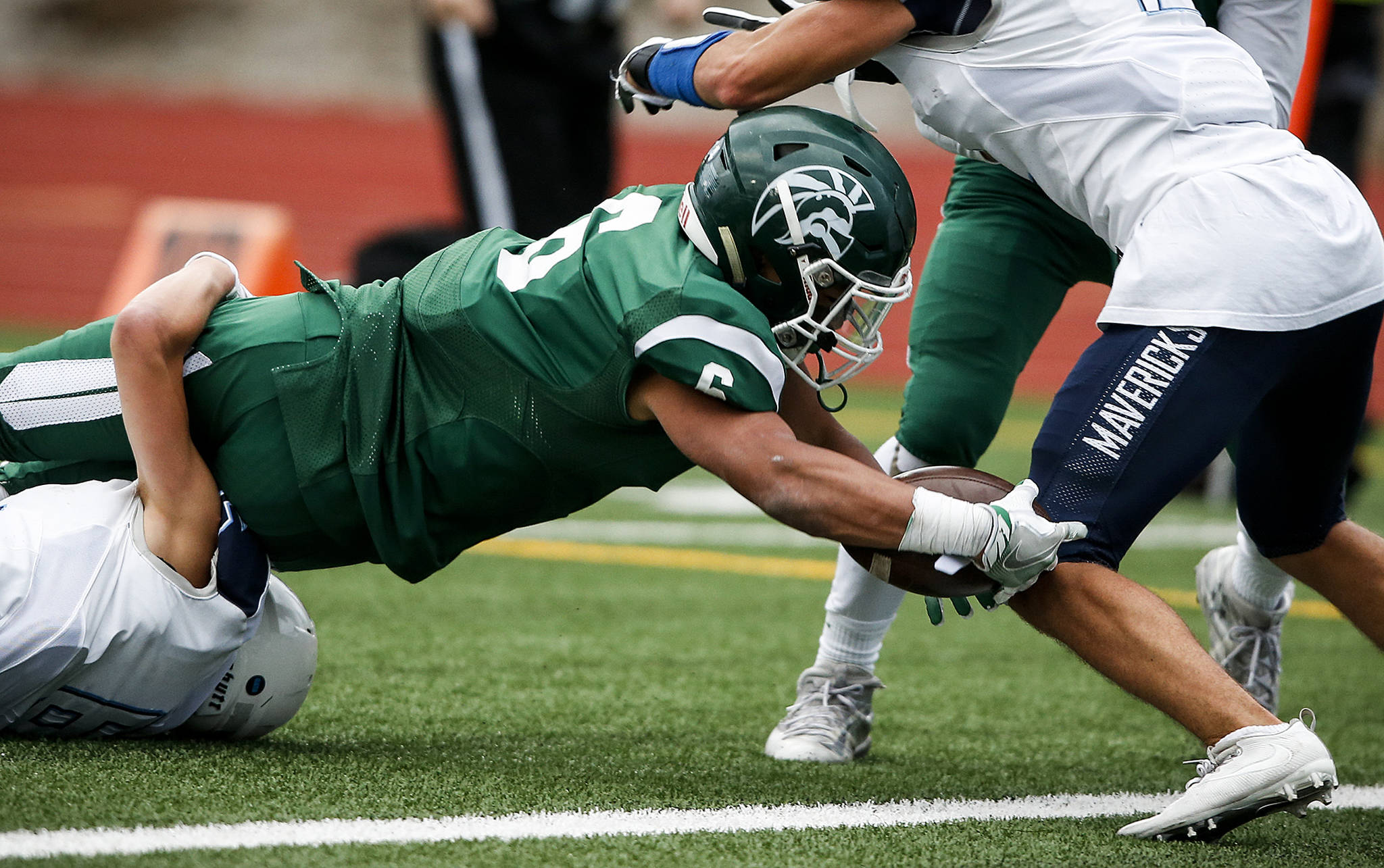 Edmonds-Woodway’s Capassio Cherry dives into the end zone for a touchdown during a game against Meadowdale on Oct. 6, 2017, at Edmonds Stadium. (Ian Terry / The Herald)