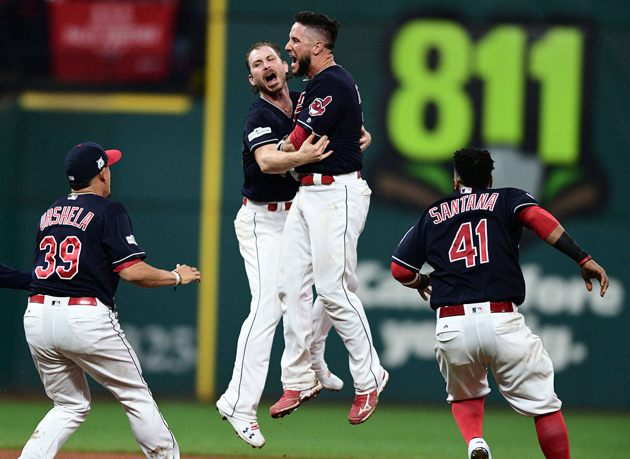 Indians starting pitcher Josh Tomlin celebrates with Yan Gomes (second from right) after Gomes hit a game-winning single in the 13th inning of Game 2 of the American League Division Series against the Yankees on Oct. 6, 2017, in Cleveland. (AP Photo/David Dermer)