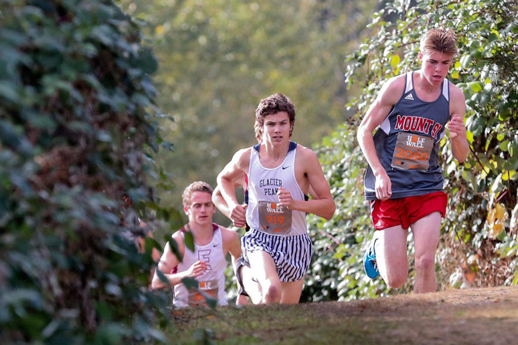 Mount Si, Joe Waskom, right, leads the pack Saturday afternoon during the 34th annual Hole in the Wall Cross Country Invitational at Lakewood High School in Arlington on October 7th, 2017. (Kevin Clark / The Herald)
