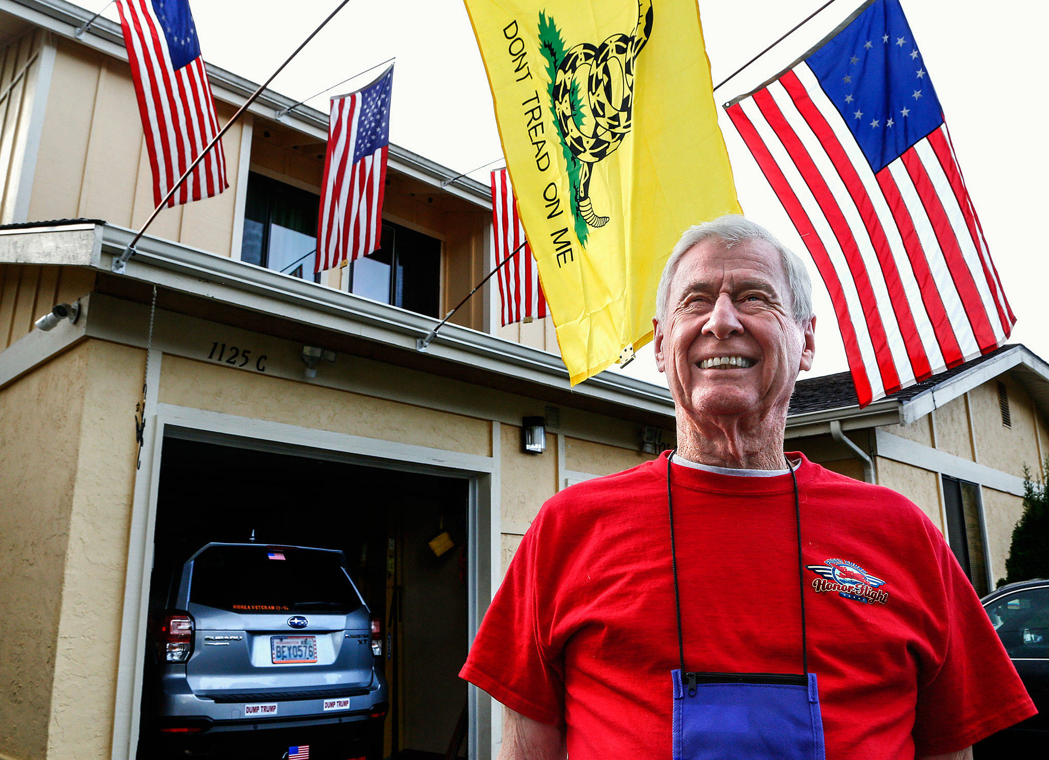Korean War veteran Gerald Rogers, 85, of Everett, flies American flags outside his condominium in south Everett. Rogers recently took an Honor Flight trip to Washington, D.C. (Dan Bates / The Herald)