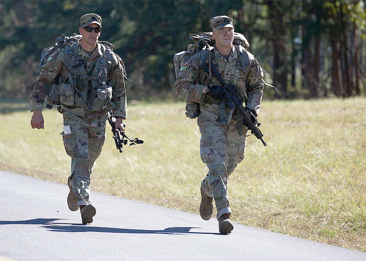 U.S. Army Sgt. Grant Reimers (left), assigned to U.S. Army National Guard, and Sgt. Kevin Beuse, assigned to U.S. Army Cyber Command, conduct a 15-mile ruck march while competing in the Best Warrior Competition at Fort A.P. Hill, Va., Oct 2, 2017. (U.S. Army photo by Pfc. Miguel Pena)