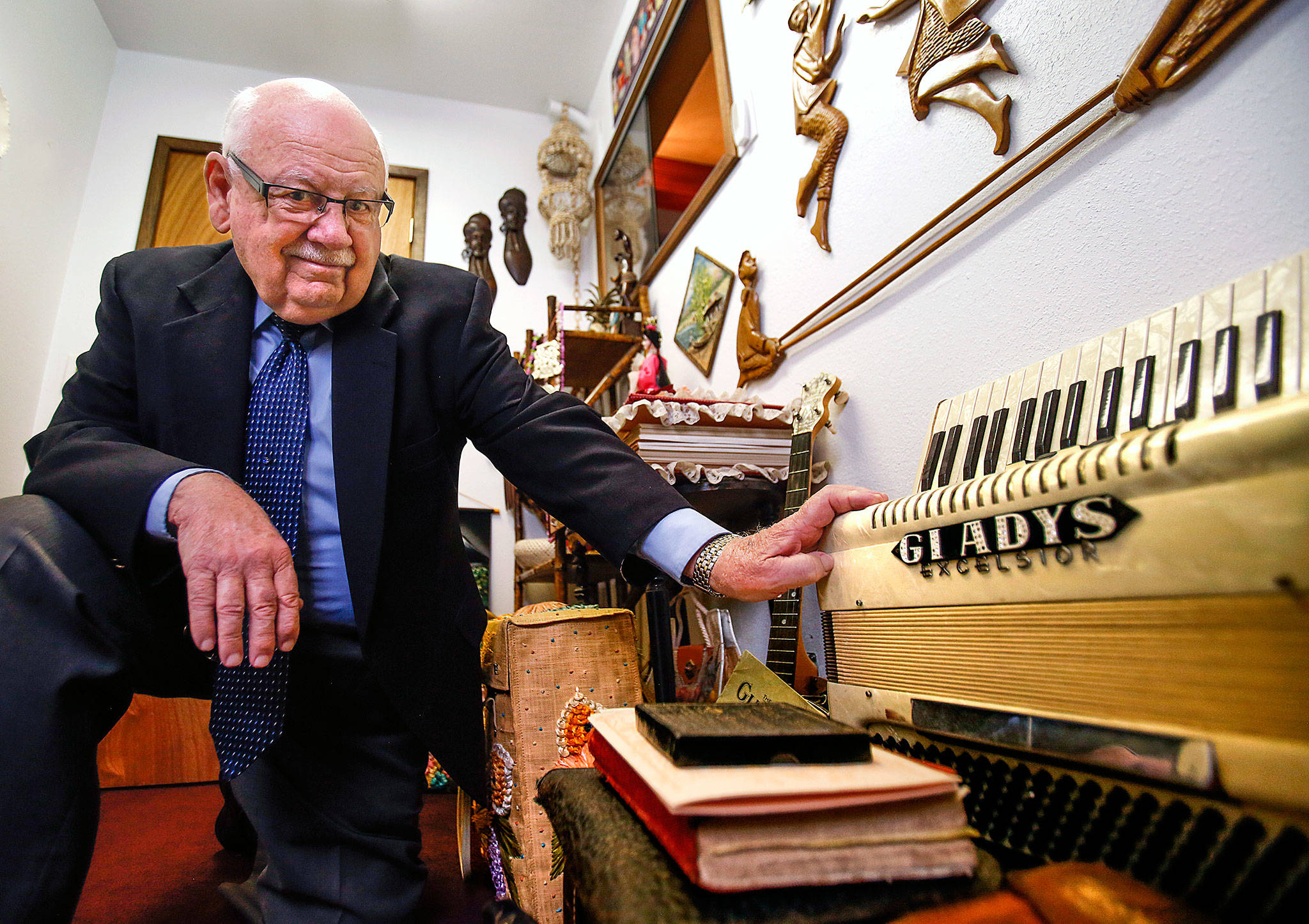 At the Gospel Light Church in Everett, founding member and longtime pastor, Newton Waldrop offers a peek inside a small room filled with memories covering several generations of his family who served here. His mother, Gladys, played the accordion at right as well as the banjo. (Dan Bates / The Herald)