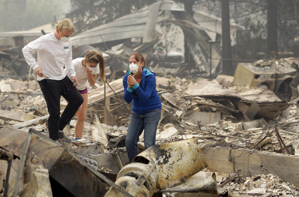Jeff Chiu / associated press 
Mary Caughey (right) reacts after finding her wedding ring in the debris at her home in Kenwood, California, on Tuesday.

