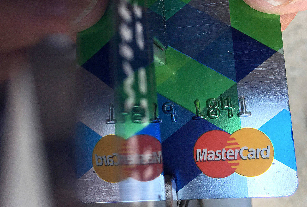 A customer inserts a credit card to pay for parking in Haverhill, Massachusetts, in June. (AP Photo/Elise Amendola)