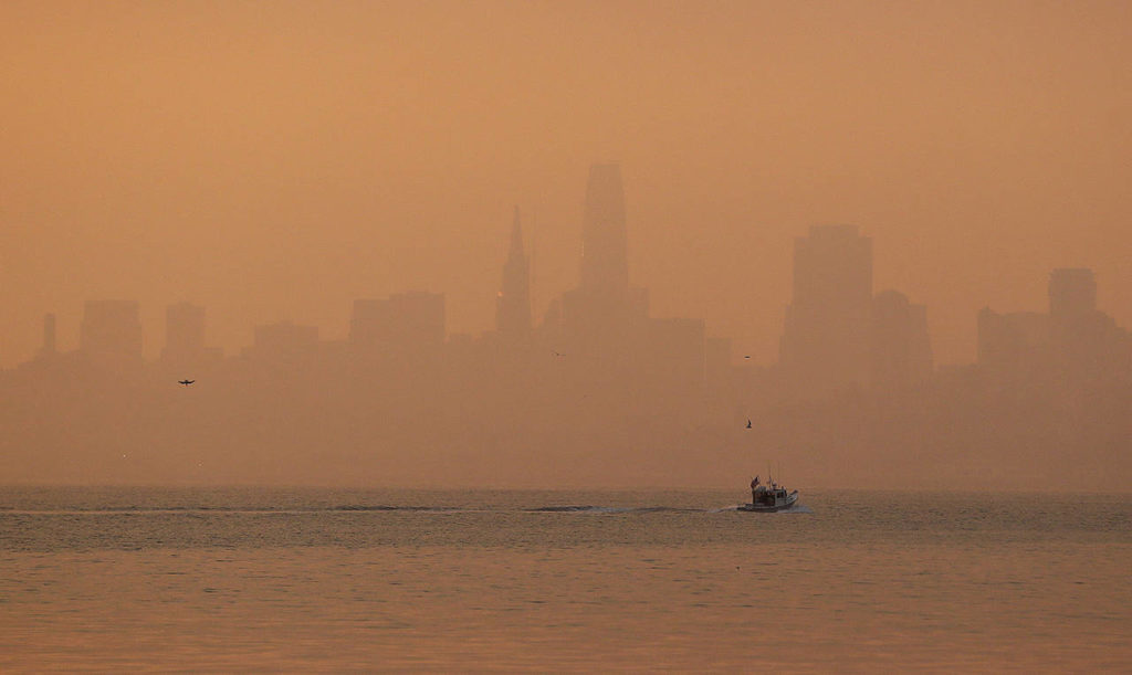 The San Francisco skyline is obscured by smoke and haze from wildfires Thursday in this view from Sausalito, Califorina. (AP Photo/Eric Risberg)

