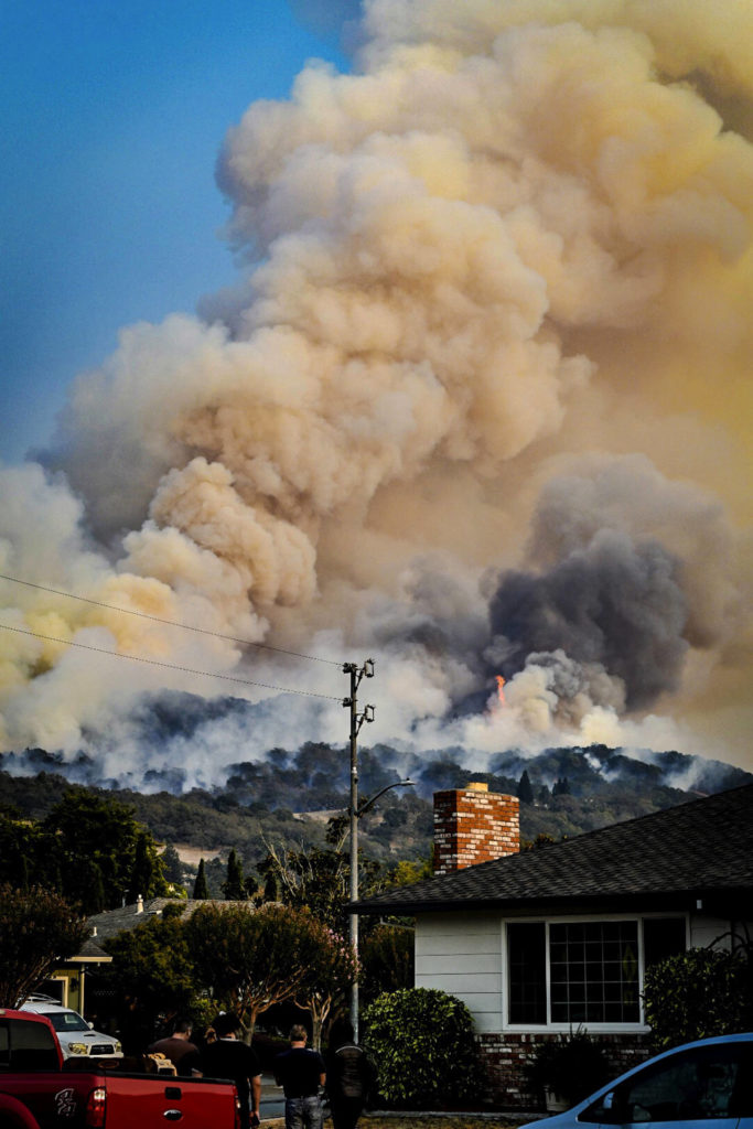 In this Oct. 11 photo, smoke rises from fires in Santa Rosa, California. (Derek Anderson via AP)
