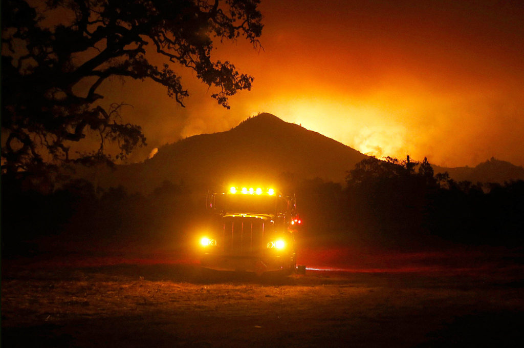 Flames rise from a hillside east of Santa Rosa, California, on Tuesday, sending residents on a headlong flight to safety through smoke and flames as homes burn. (Nhat Meyer/San Jose Mercury News)
