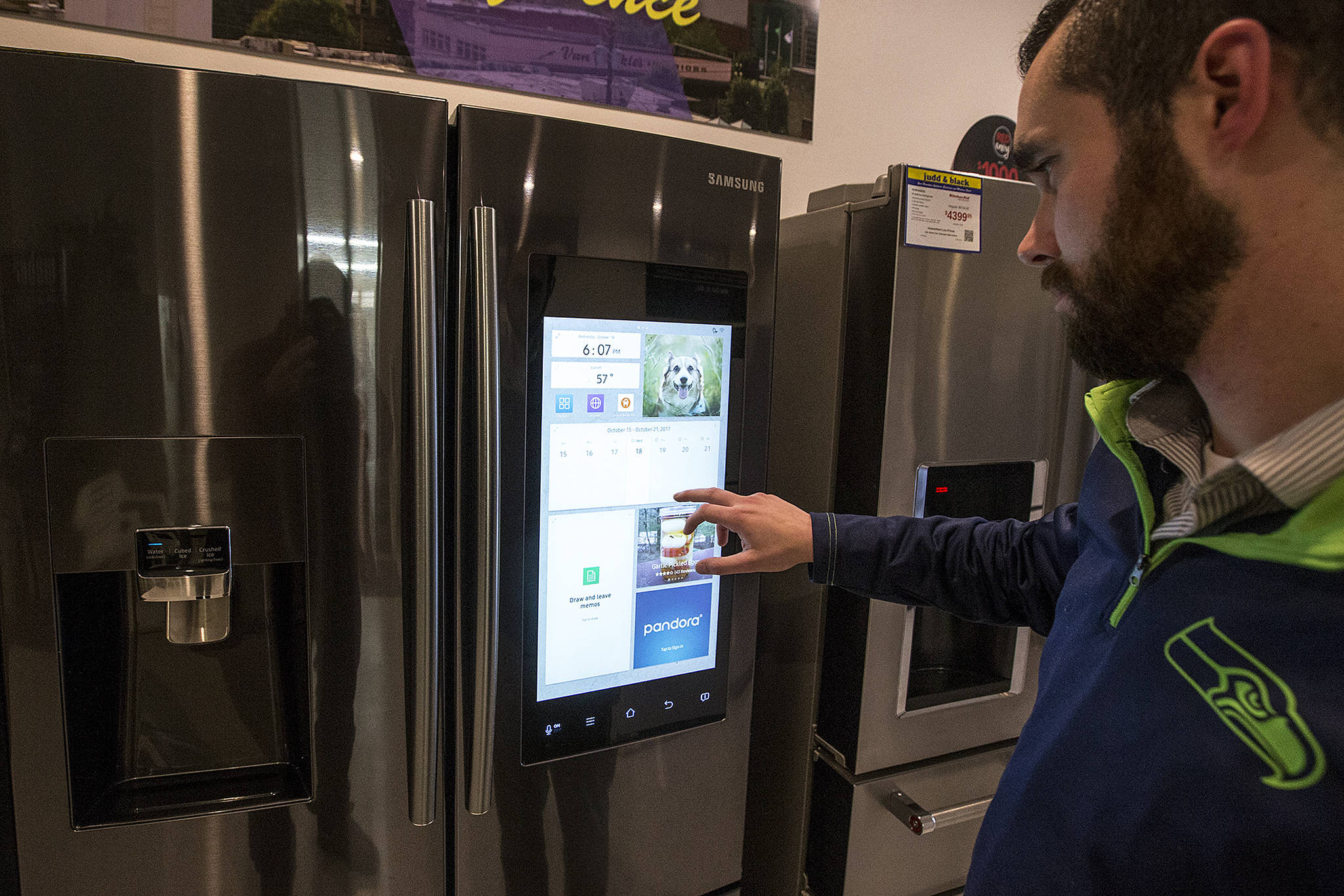 Taylor Long, a sales associate at Judd & Black, flips through the touchscreen on Samsung’s Family Hub refrigerator that will be one of the many products on display and sale at the Everett Fall Home Show on Oct. 27, 28 and 29 at Xfinity Arena in Everett. (Ian Terry / The Herald)
