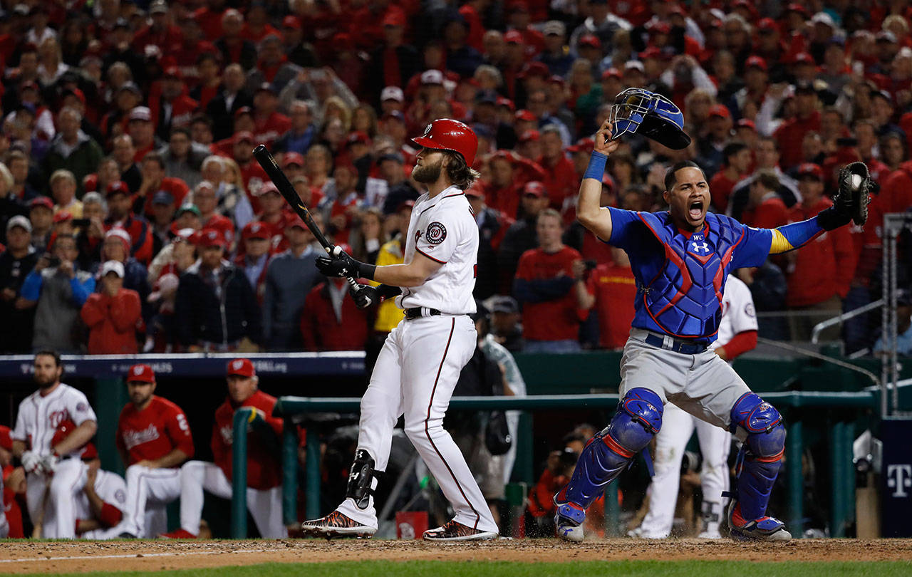 Cubs catcher Willson Contreras (right) begins to celebrate after the Nationals’ Bryce Harper struck out swinging to end Game 5 of a National League Division Series on Oct. 12, 2017, at Nationals Park in Washington, D.C. (AP Photo/Pablo Martinez Monsivais)