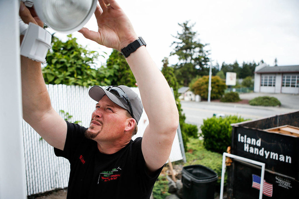 Brian Dernbach works on one of his rental properties in Oak Harbor. Dernbach’s business is Island Handyman. (Ian Terry / The Herald)
