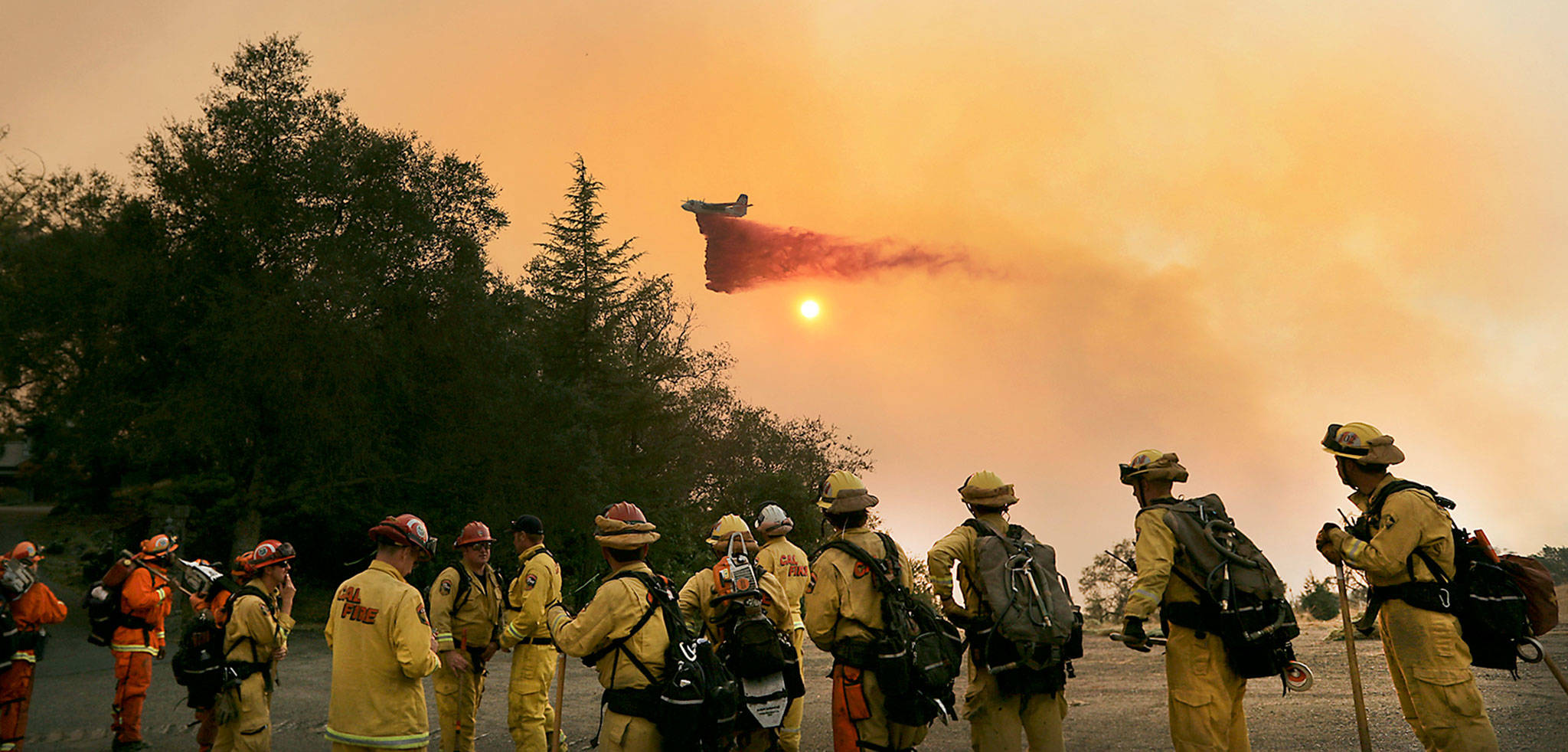 An air tanker drops retardant on a wildfire near Geyserville, California, on Thursday. (Kent Porter/The Press Democrat via AP)