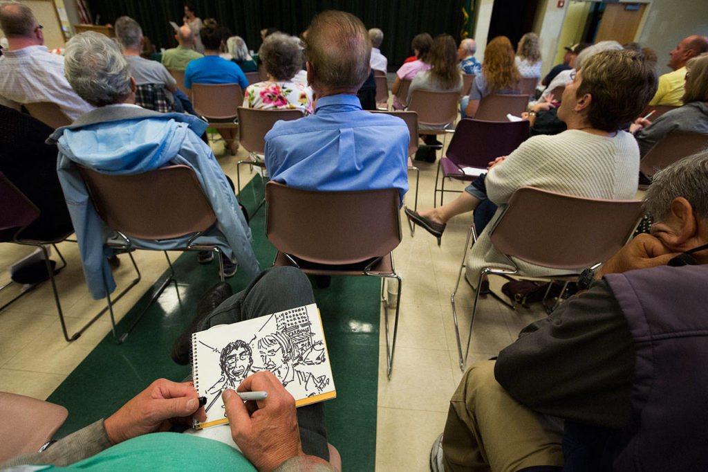 An artist draws Cassie Franklin and Judy Tuohy as they answer questions during the Everett mayoral candidates debate Sept. 11. (Andy Bronson / The Herald) 
