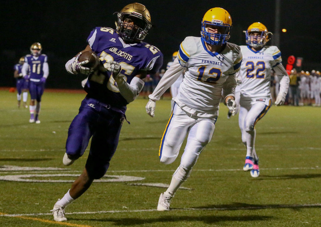Oak Harbor’s Tamarik Hollins-Passmore races and scores a touchdown with Ferndale’s defense trailing during a game Oct. 13, 2017, at Oak Harbor High School. (Kevin Clark / The Herald)
