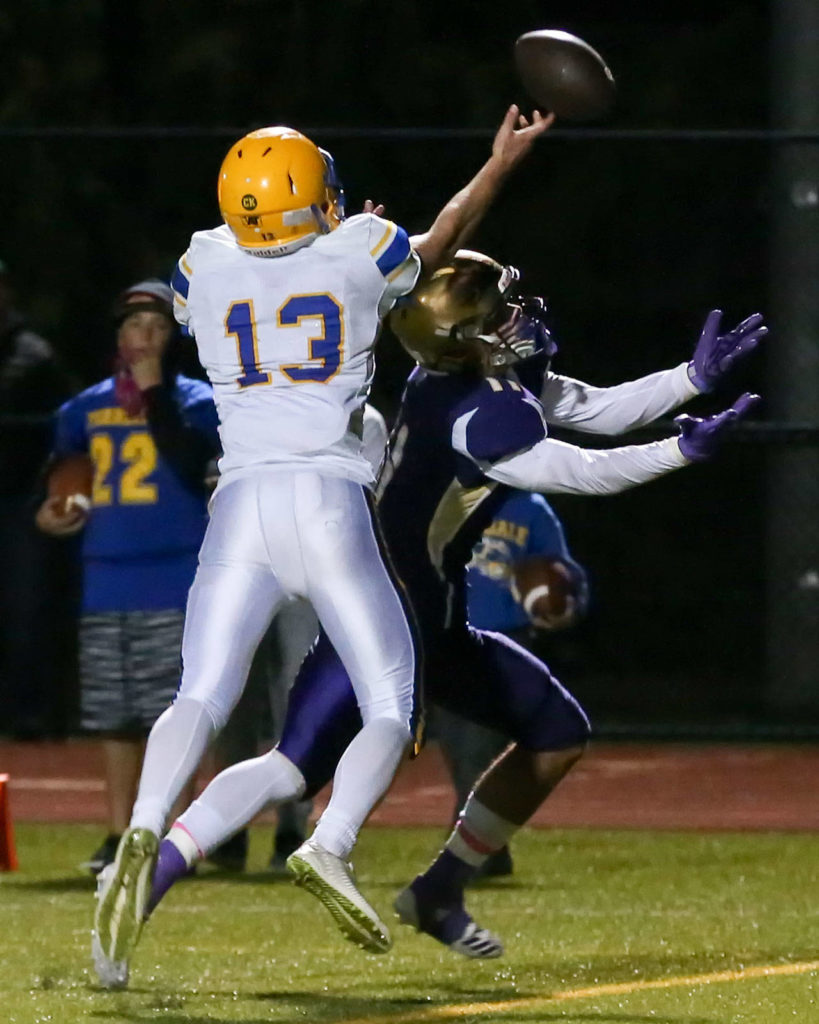 Ferndale’s James Hinson deflects a reception attempt from Oak Harbor’s Kyle Nickols during a game Oct. 13, 2017, at Oak Harbor High School. (Kevin Clark / The Herald)
