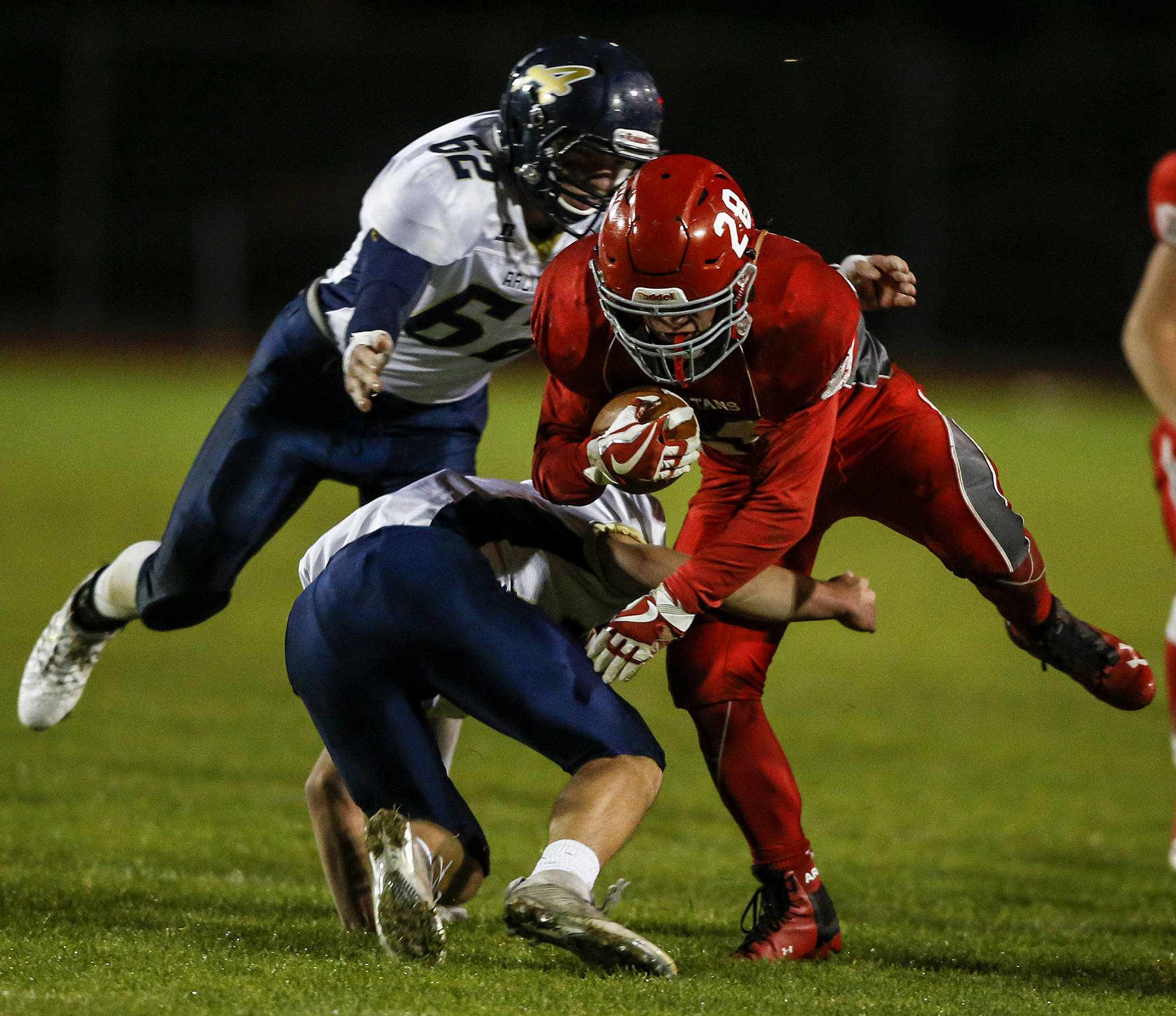 Stanwood’s Tyler Rich plows through Arlington defenders during the annual Stilly Cup game at Stanwood High School on Oct. 13, 2017. (Ian Terry / The Herald)