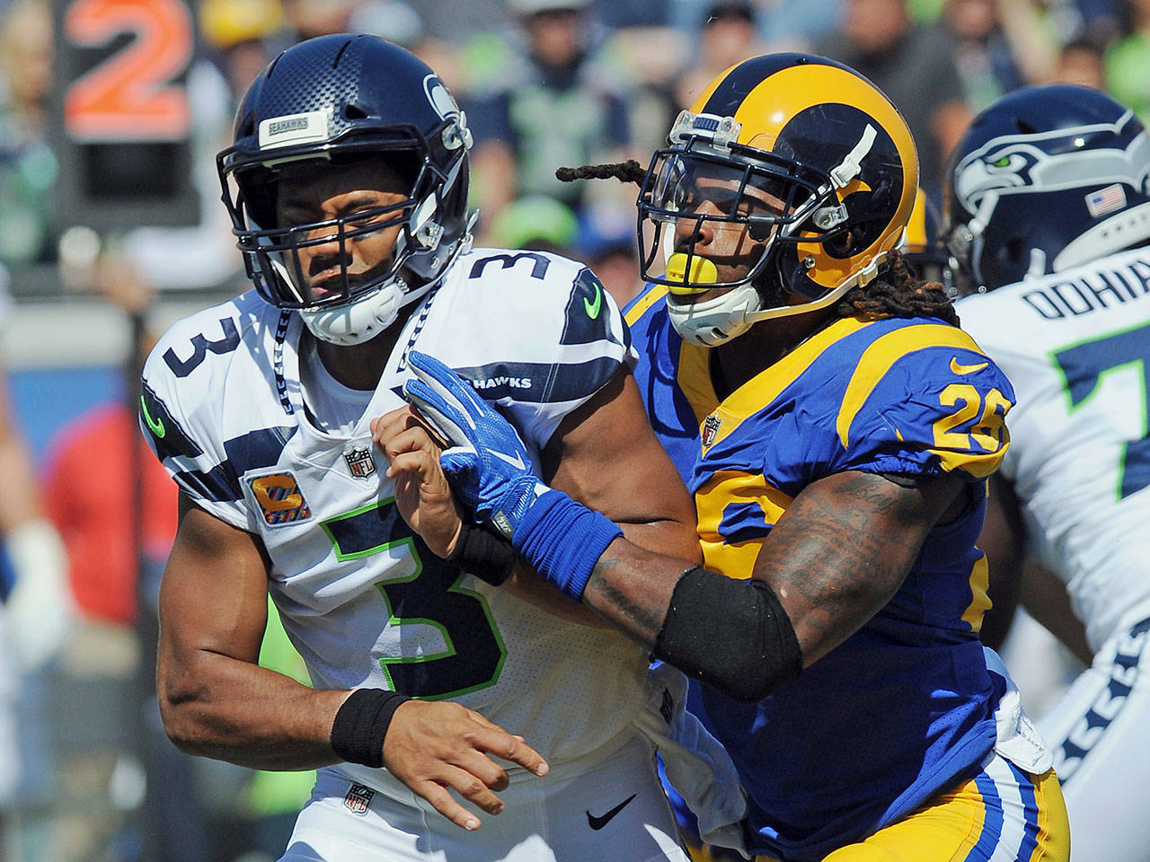 Seahawks quarterback (3) Russell Wilson gets hit after a pass by Rams linebacker (26) Mark Barron during the first quarter of a game Oct. 8, 2017, at the Los Angeles Memorial Coliseum in Los Angeles. (AP Photo/John Cordes)