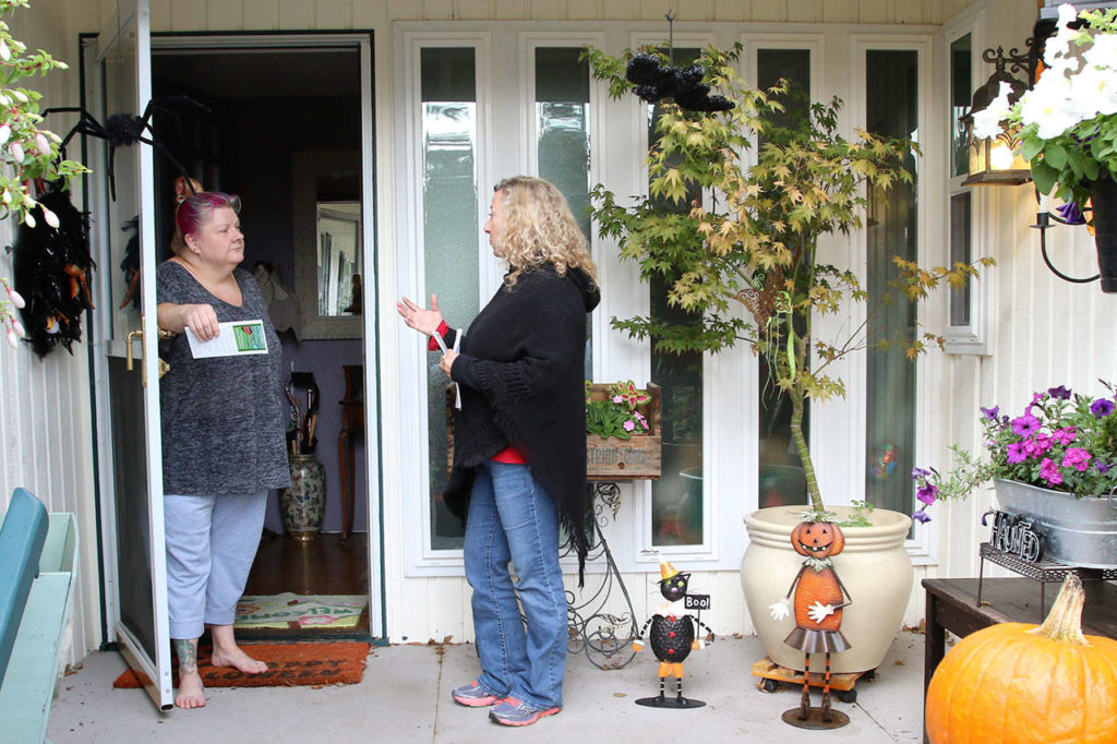 Suzie Storm talks with Kristin Kelly, candidate for Snohomish County council, Saturday afternoon in unincorporated Everett. (Kevin Clark / The Herald)
