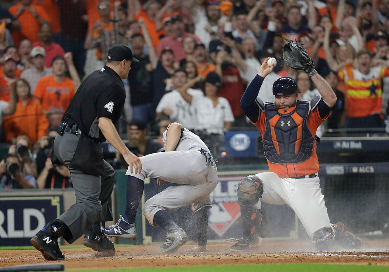 Astros catcher Brian McCann reacts after tagging out the Yankees’ Greg Bird at home during the fifth inning of Game 1 of the American League Championship Series on Oct. 13, 2017, in Houston. (AP Photo/David J. Phillip)