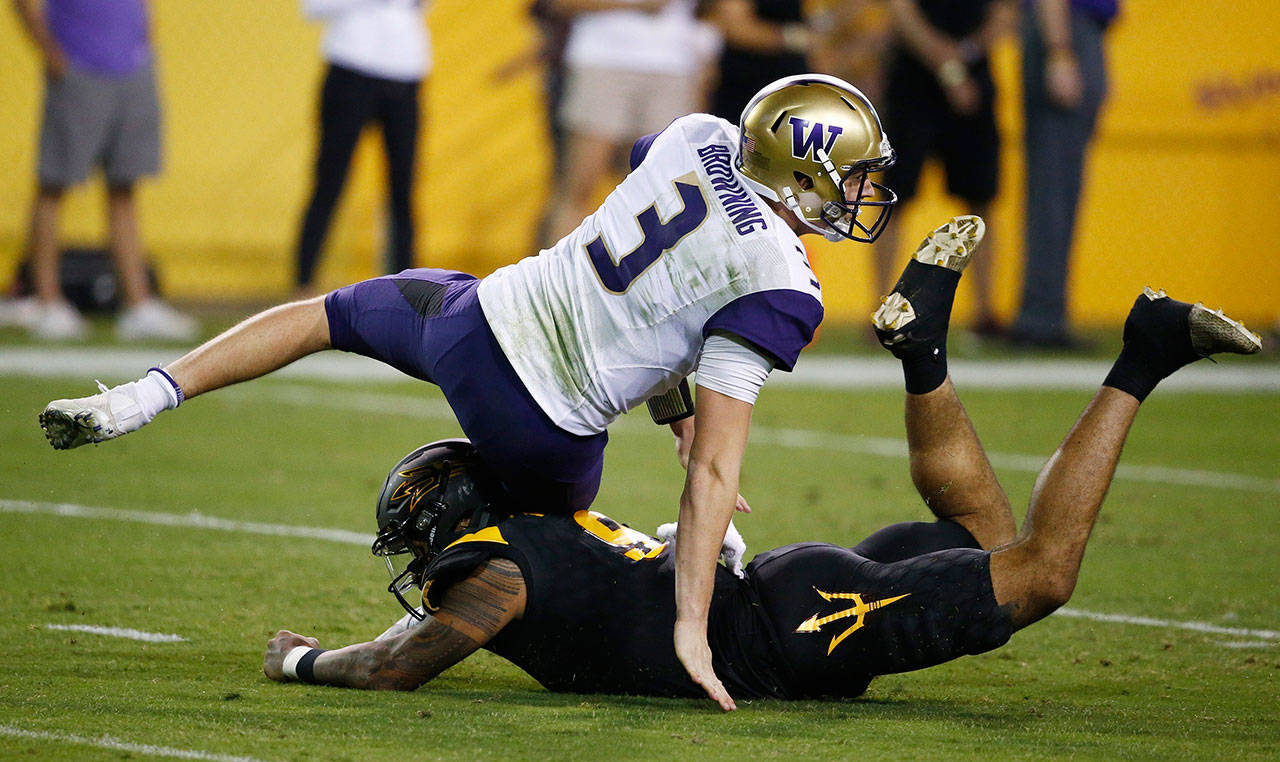 Washington quarterback Jake Browning (3) gets taken down by Arizona State’s Jay Jay Wilson (9) during the first half of a game Oct. 14, 2017, in Tempe, Ariz. (AP Photo/Ross D. Franklin)